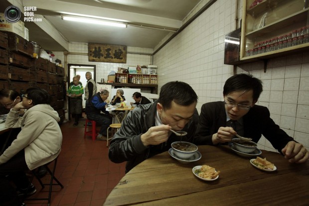 Customers eat snake soup at a snake soup shop in Hong Kong